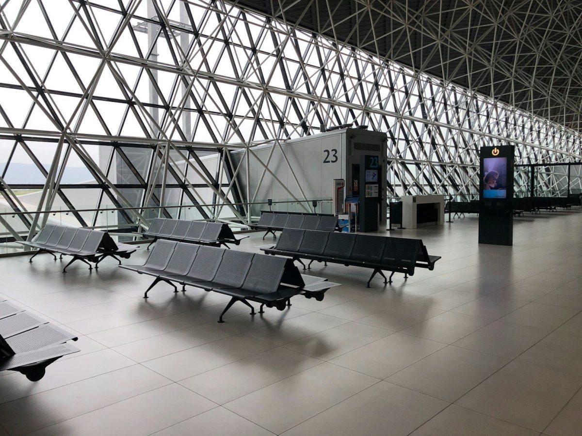 7 Tricks for Finding the Best Airfare Deals in 2026 6 black metal gang chairs on white ceramic flooring