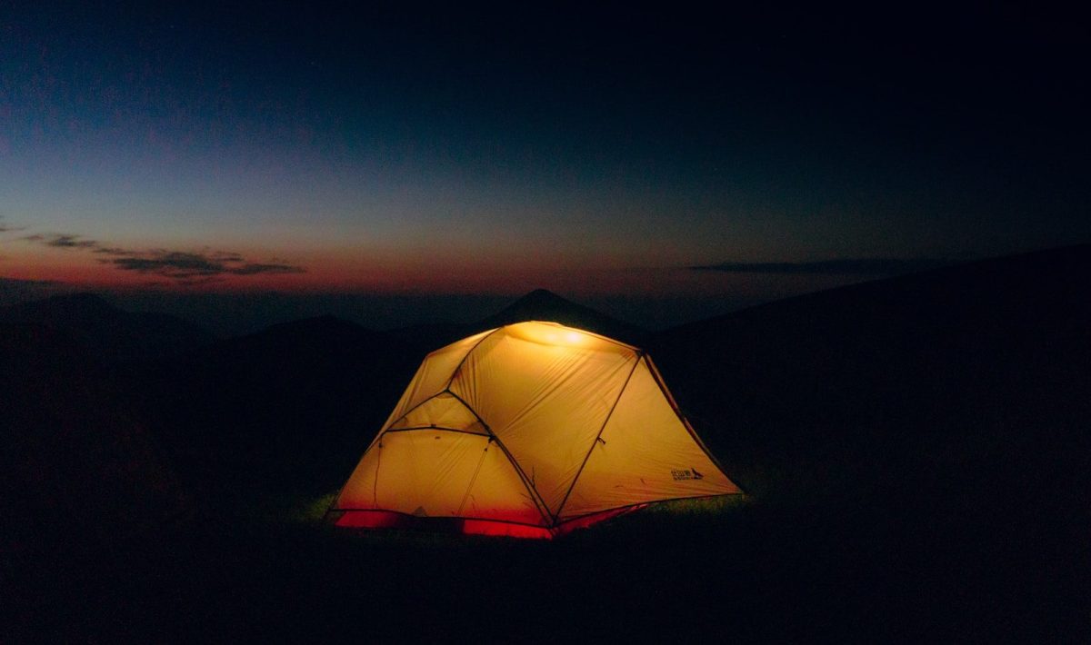 8 Ways to Stay Warm and Comfortable While Traveling in the Wilderness 8 a tent is lit up in the dark