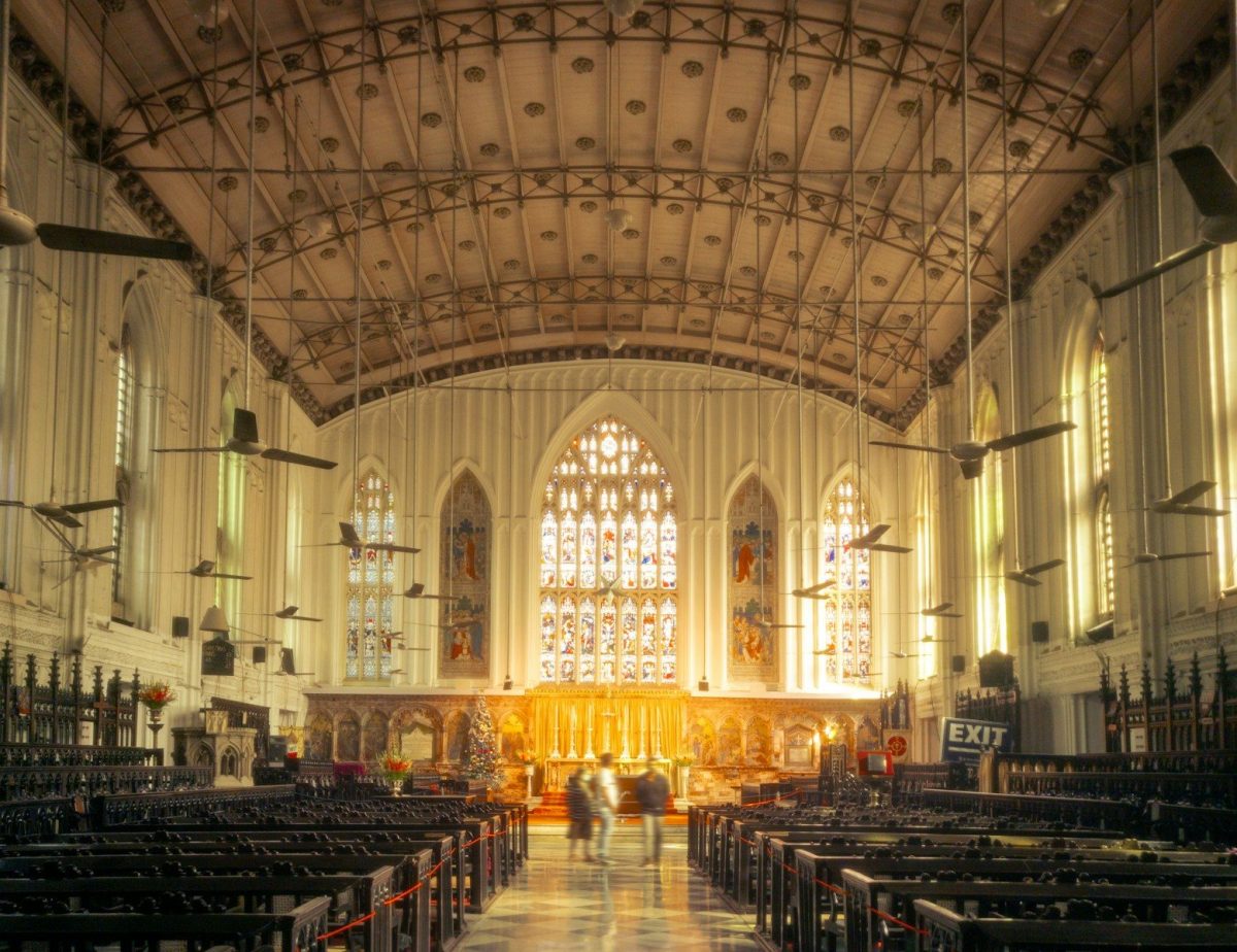 A large cathedral with a lot of pews in it