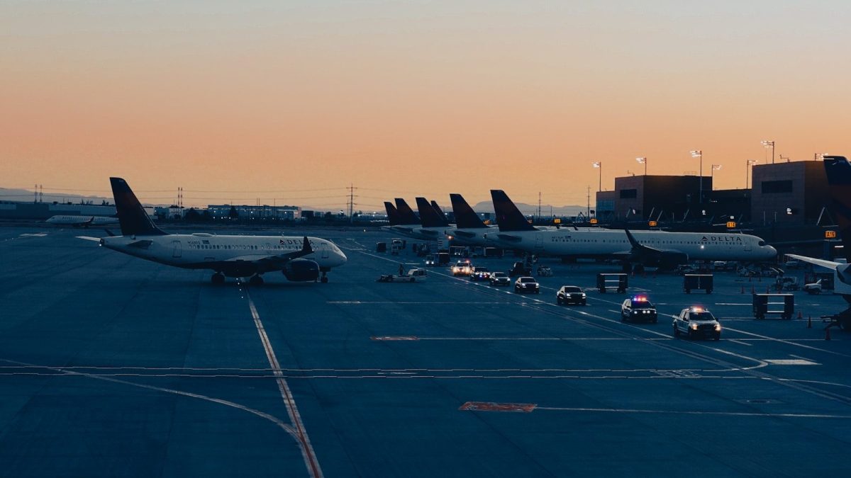 A group of airplanes parked on a runway