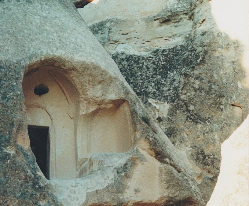 a stone building with a rope hanging from it's side