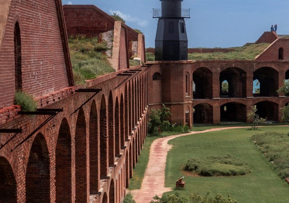 A large brick building with a light house in the background