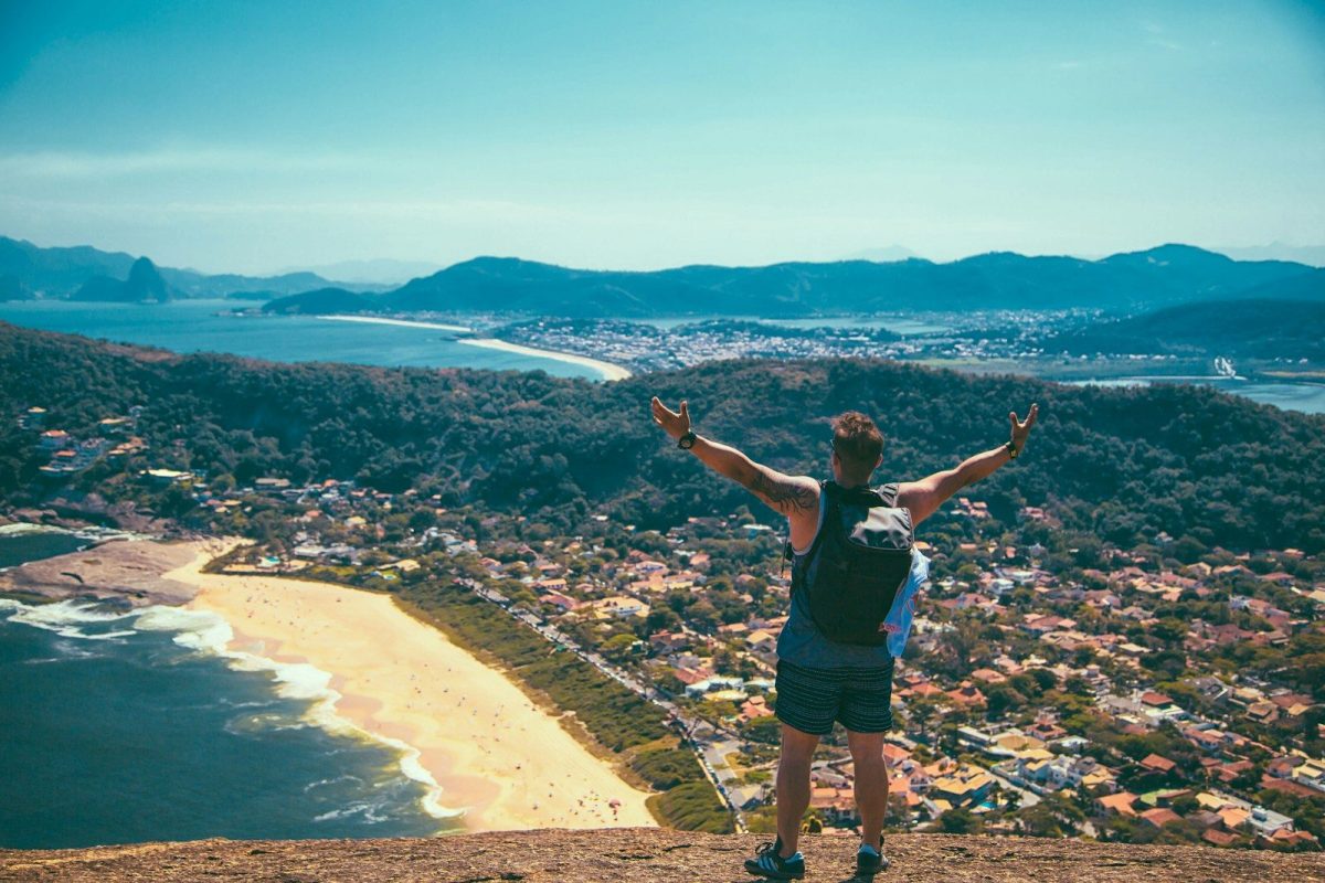 9 Essential Safety Tips for Solo Travelers 3 man standing front of seashore and houses