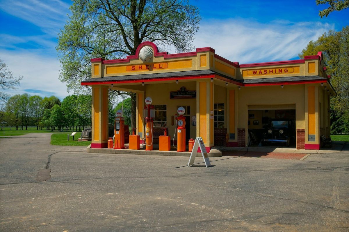 a yellow gas station with a blue sky in the background