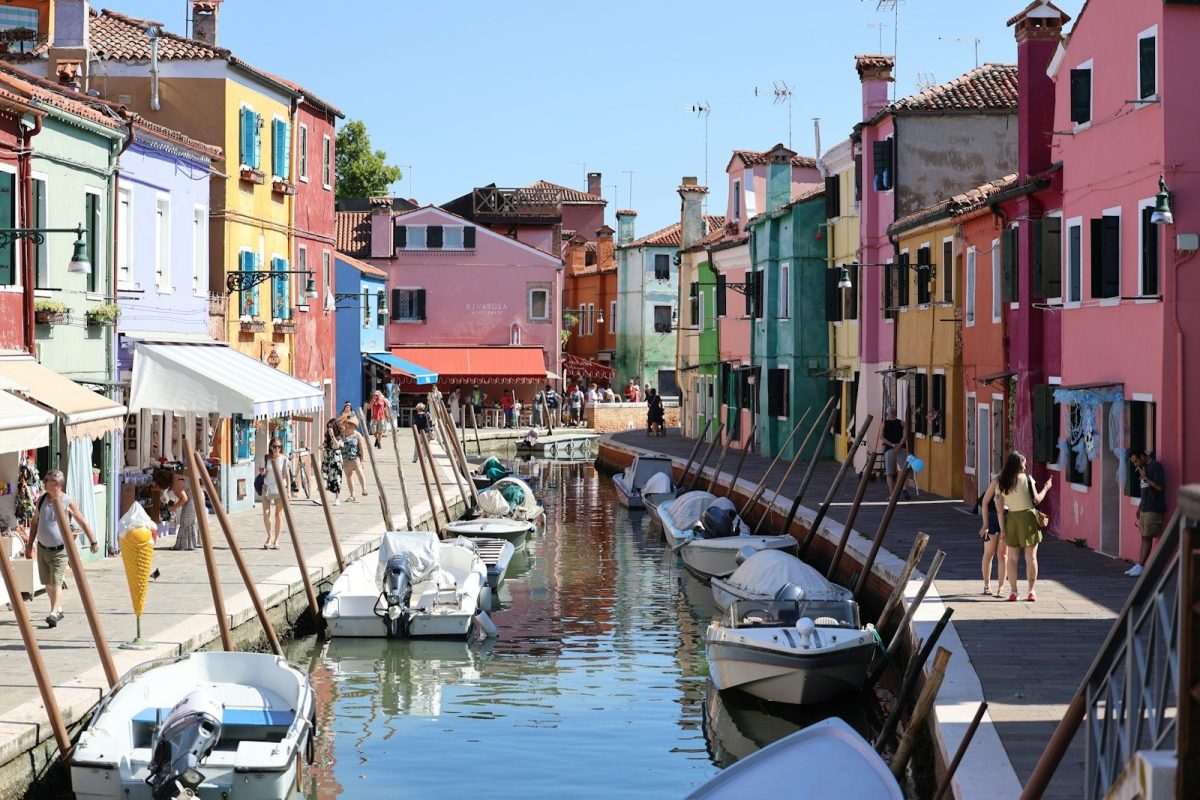 8 Beautiful Streets Around the World to Walk at Least Once 8 A group of boats that are sitting in the water