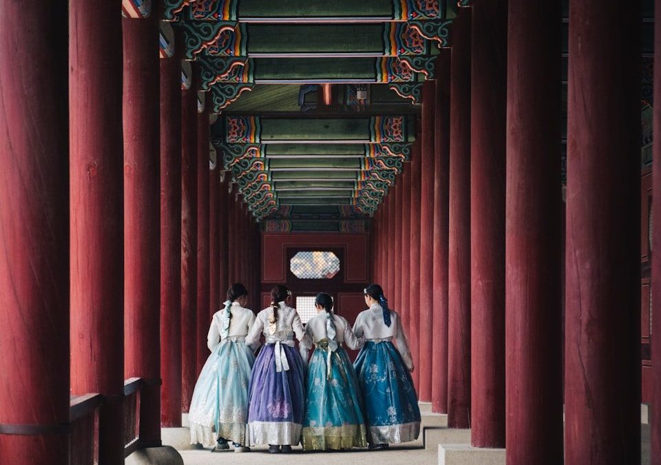 man and woman in white and blue dress walking on hallway