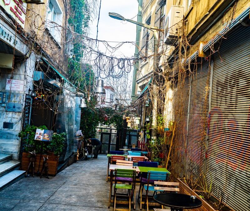 9 of the World’s Oldest Restaurants to Visit for Food and History 8 a narrow alleyway with tables and chairs