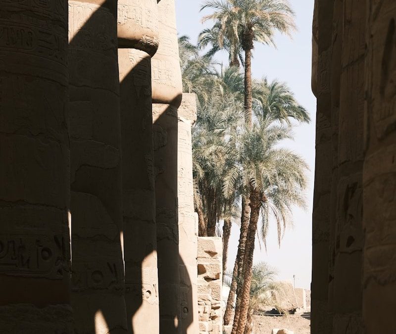 a person standing between stone pillars