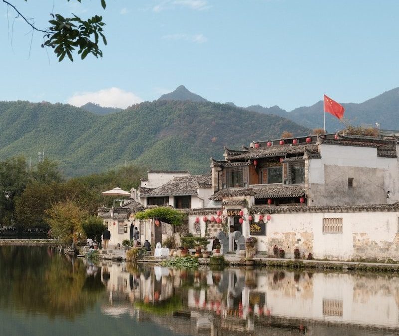 Traditional chinese village with a lake and mountains.