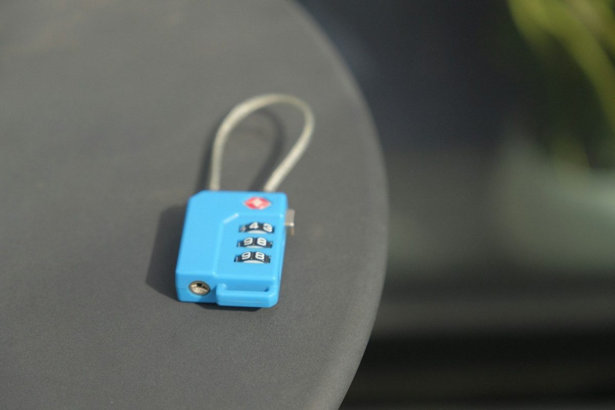 A small blue combination lock rests on a surface.