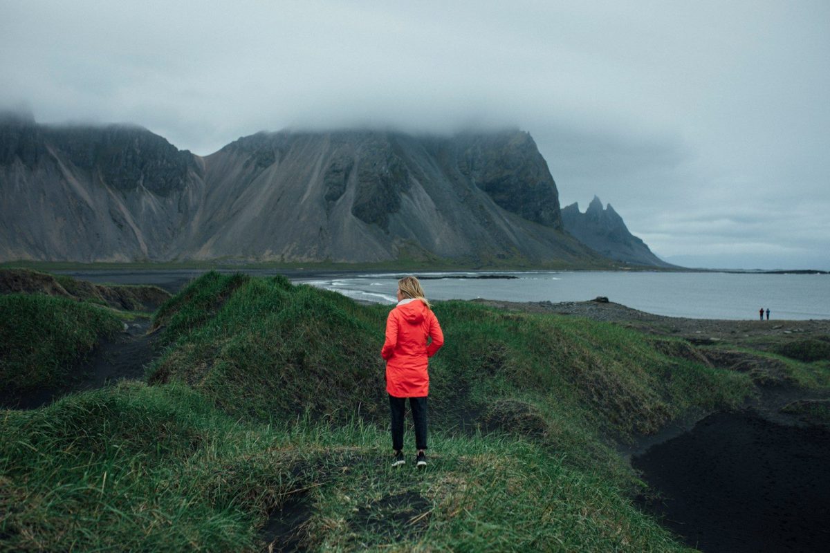 9 Essential Safety Tips for Solo Travelers 9 a person standing on a hill overlooking a body of water