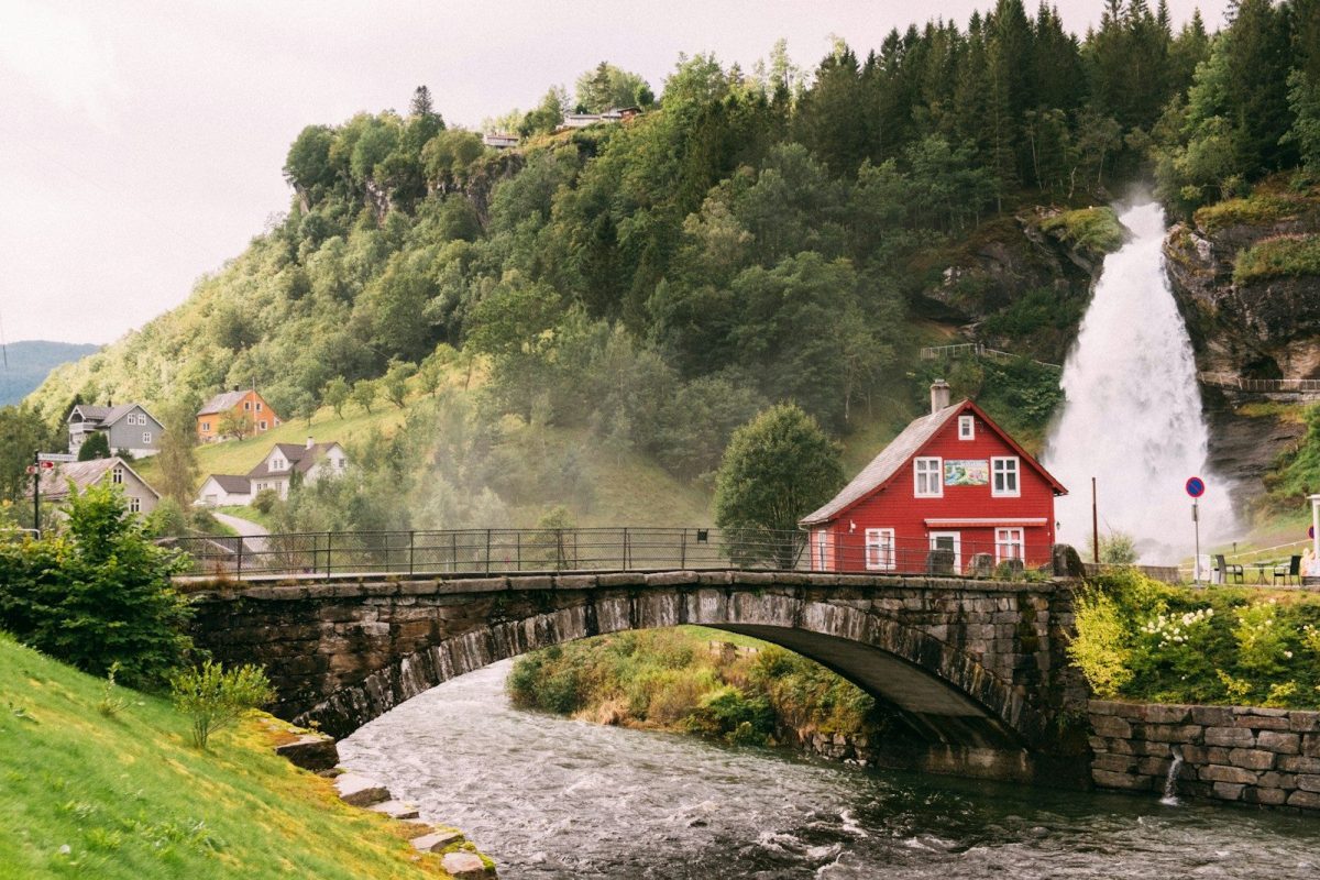 10 Countries Where Shower Habits May Surprise Travelers 10 a red house sitting on top of a lush green hillside