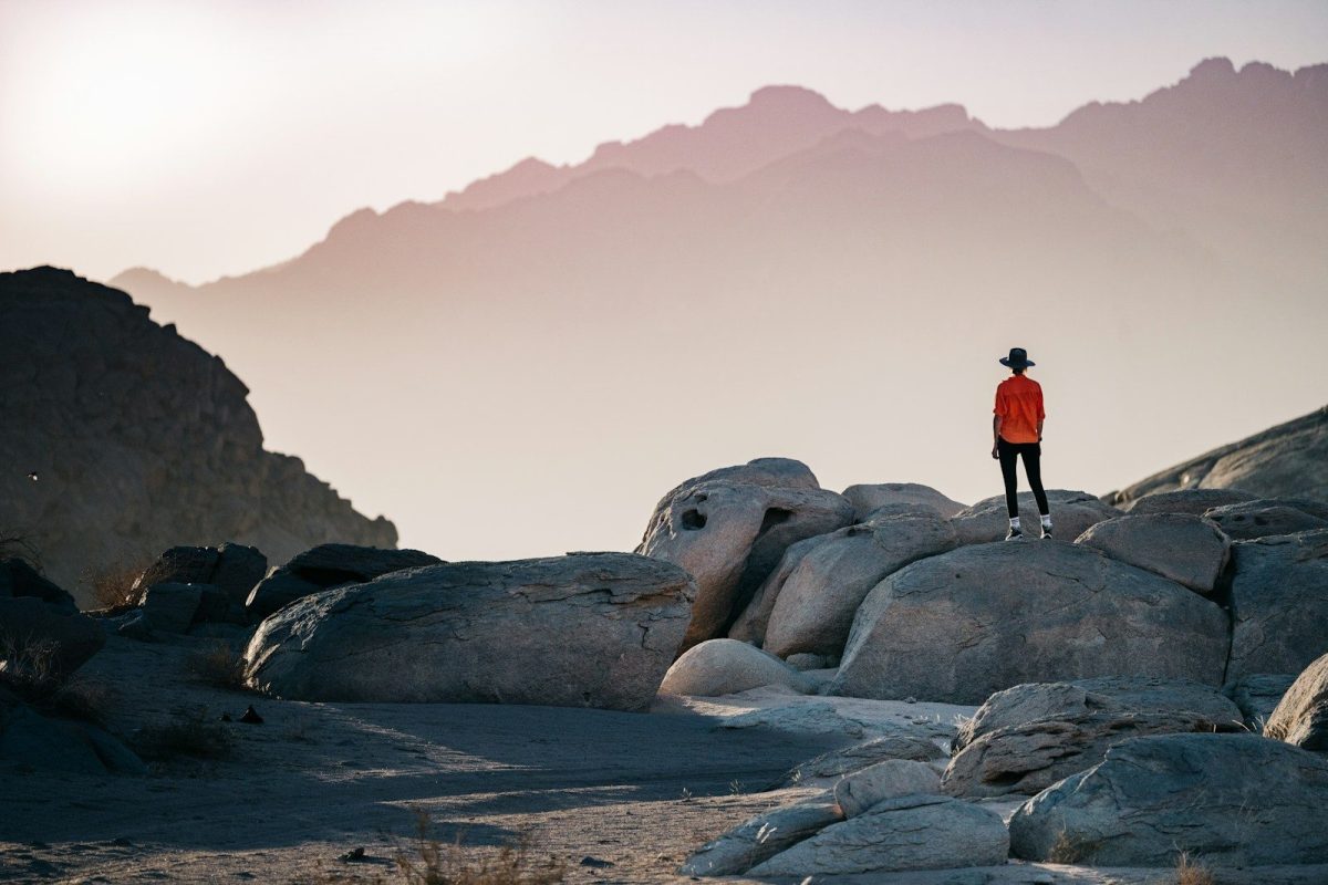 9 Essential Safety Tips for Solo Travelers 4 a person standing on top of a large rock