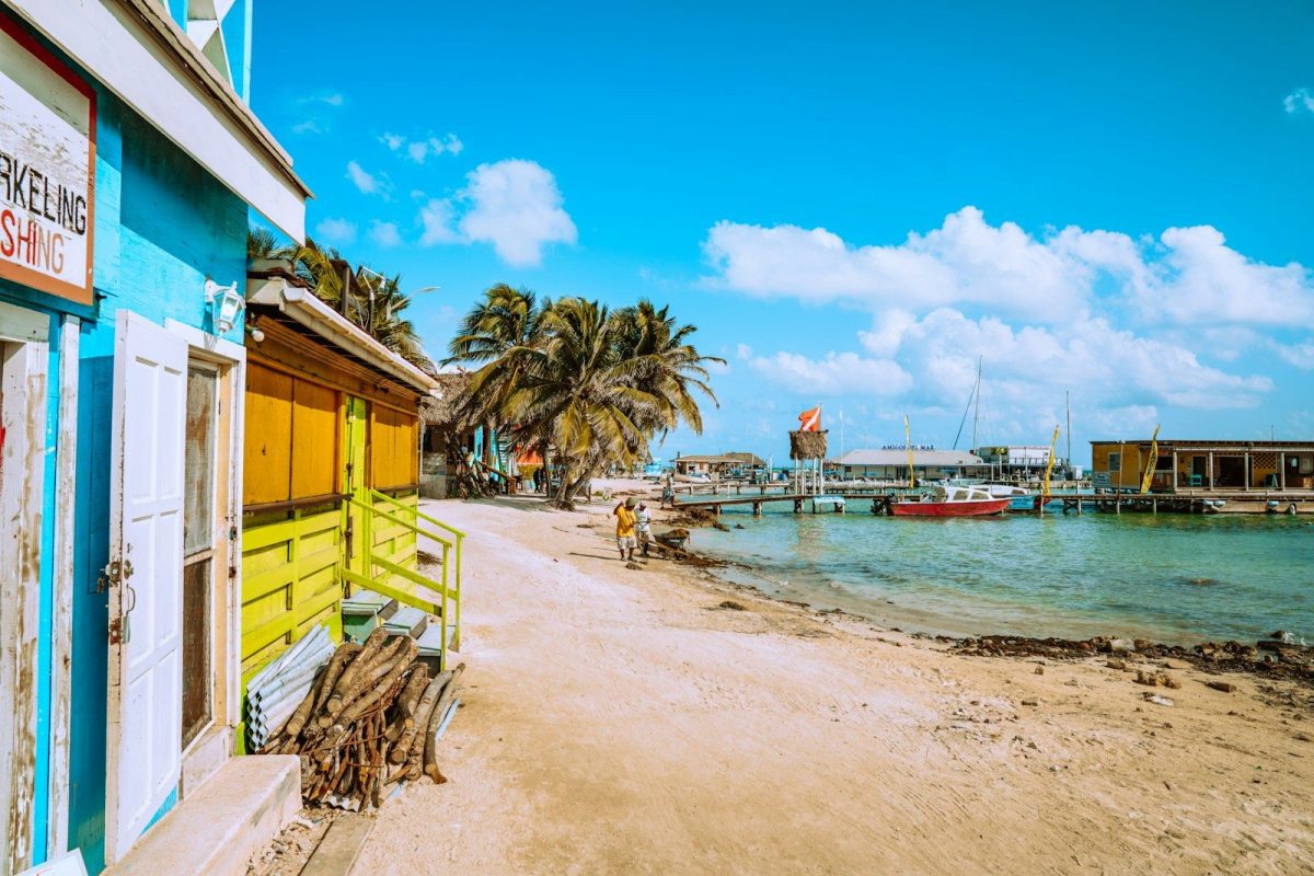 20 Happy Countries Around the World That Are Great for Travelers in 2026 4 brown wooden beach chairs near body of water during daytime