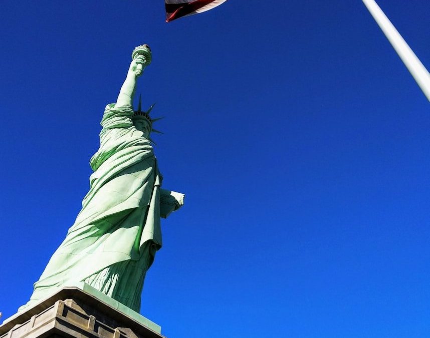 20 Happy Countries Around the World That Are Great for Travelers in 2026 7 Statue of Liberty in front USA flag under blue sky