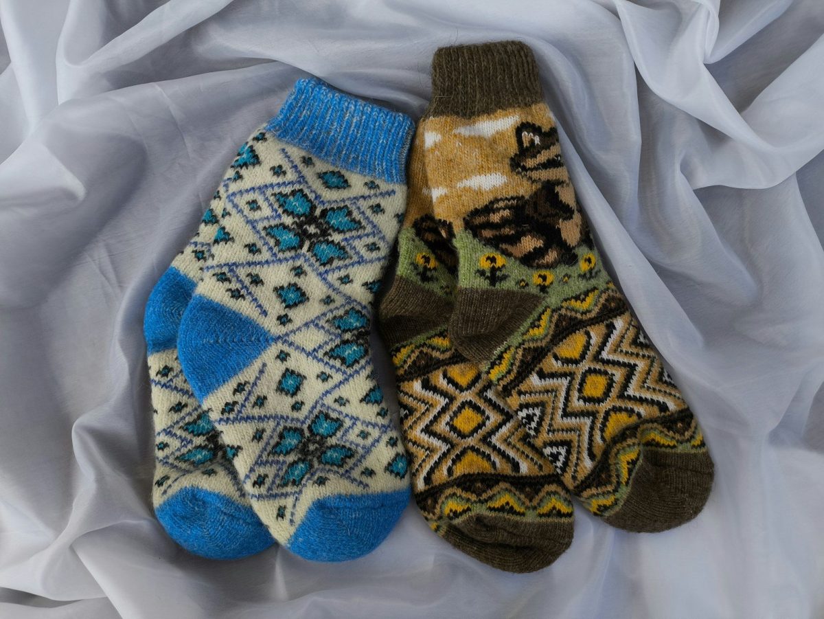 8 Ways to Stay Warm and Comfortable While Traveling in the Wilderness 6 Three pairs of patterned socks laying on a white sheet