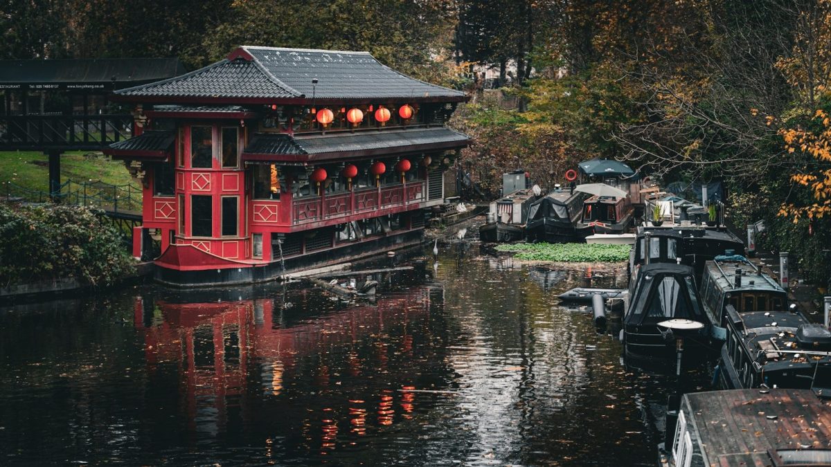A red building sitting next to a body of water