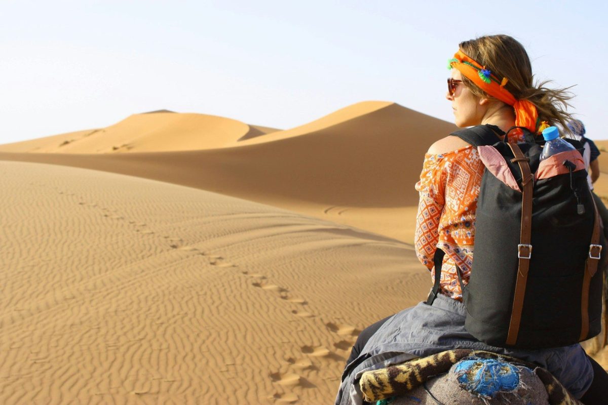 9 Essential Safety Tips for Solo Travelers 5 woman riding animal on dessert