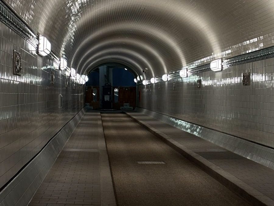 Illuminated tunnel with tiled walls and arched ceiling