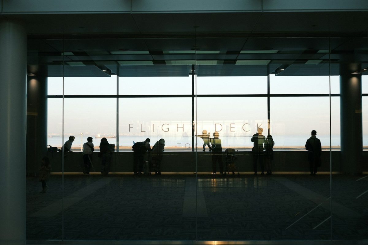 A group of people standing in front of a window