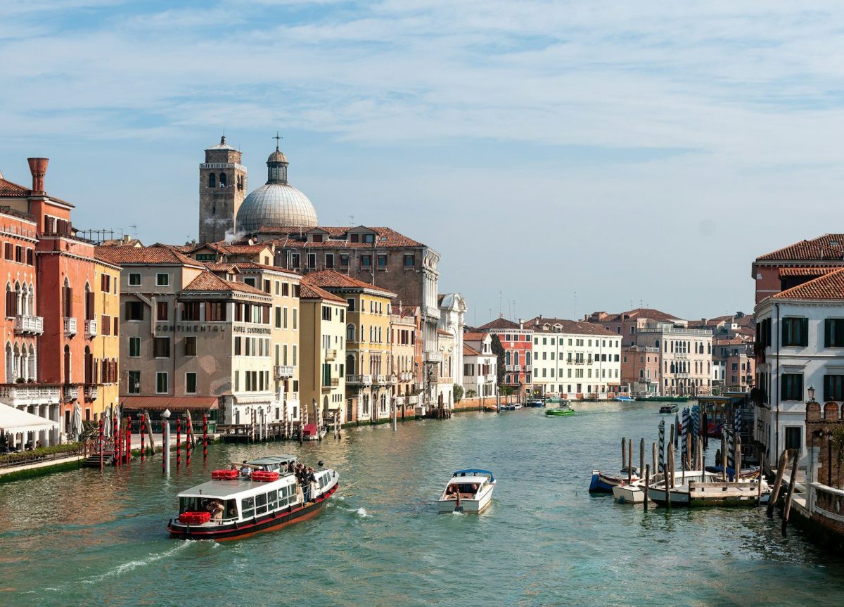 boats in a river with Grand Canal in the background