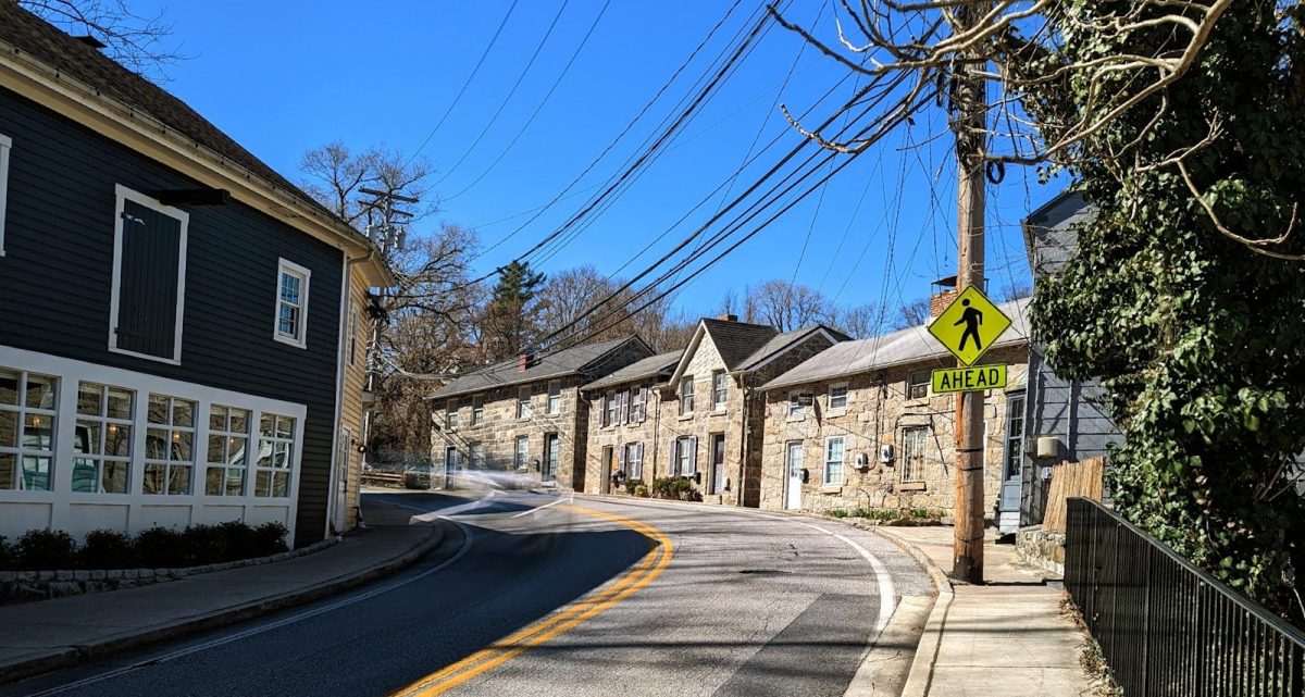 a street lined with houses next to a street sign