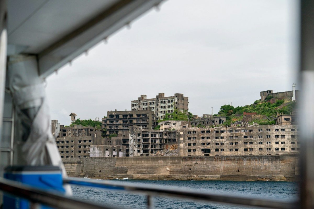 grey concrete building ruins near shore during daytime