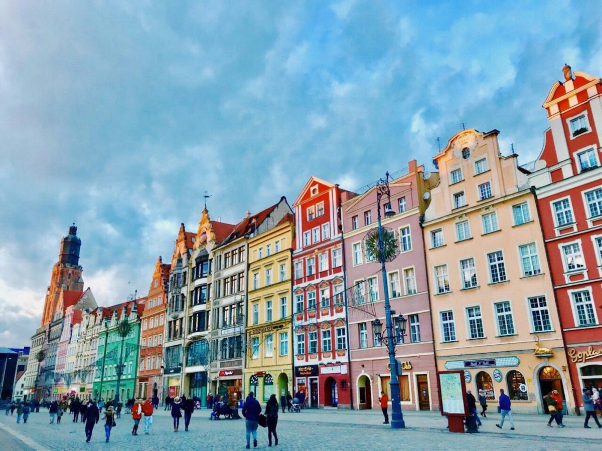 20 Happy Countries Around the World That Are Great for Travelers in 2026 6 people walking along pathway