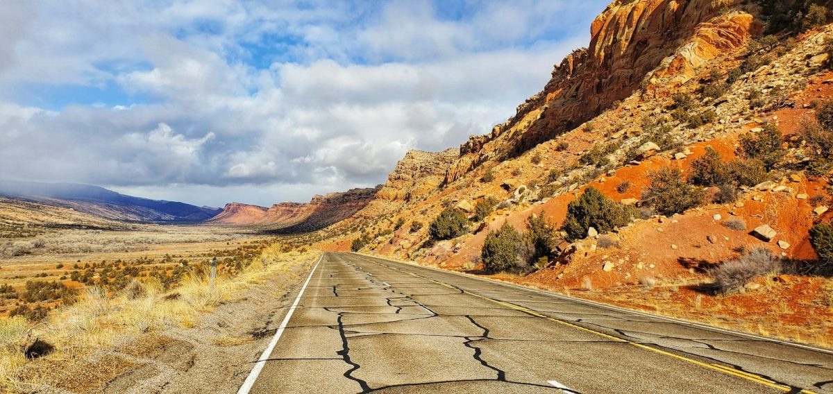 8 Reasons Some European Travelers Are Rethinking U.S. Trips 1 gray concrete road between brown mountains under white clouds and blue sky during daytime