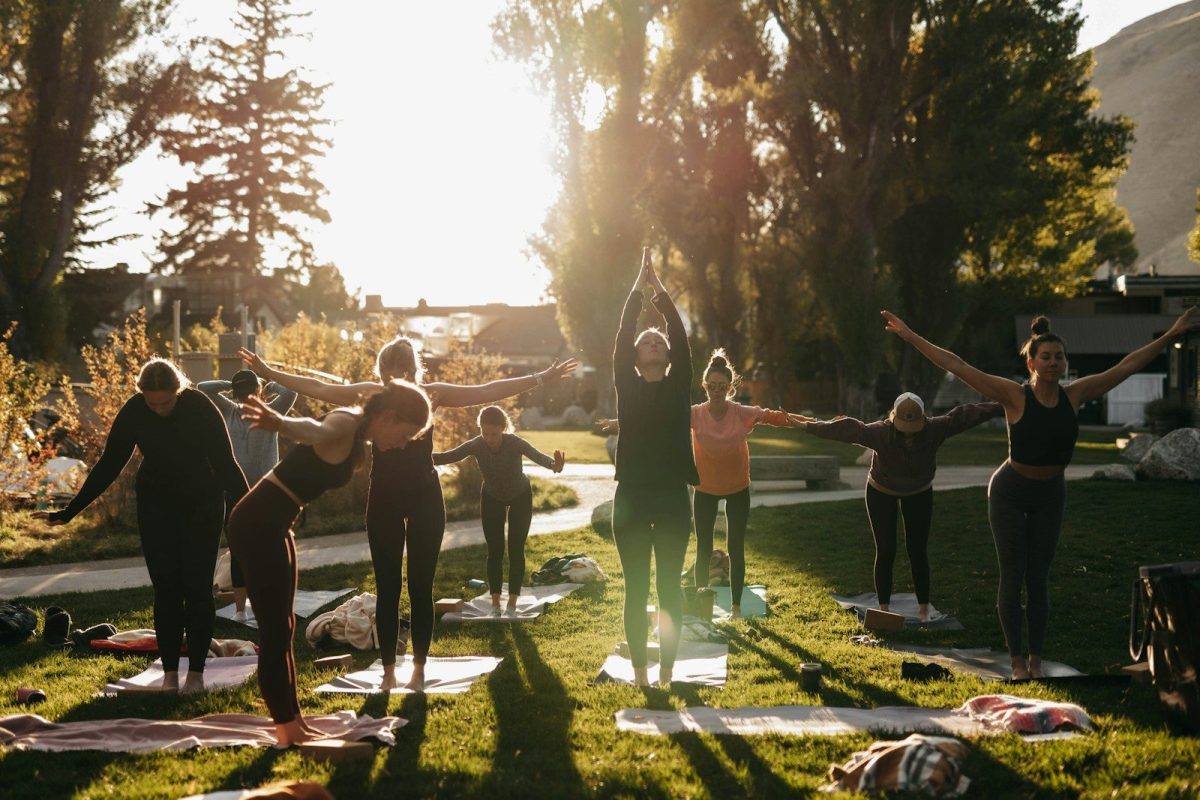 5 Luxury Wellness Retreats in the U.S. for Rest, Focus, and Mental Clarity 3 a group of people doing yoga in a park