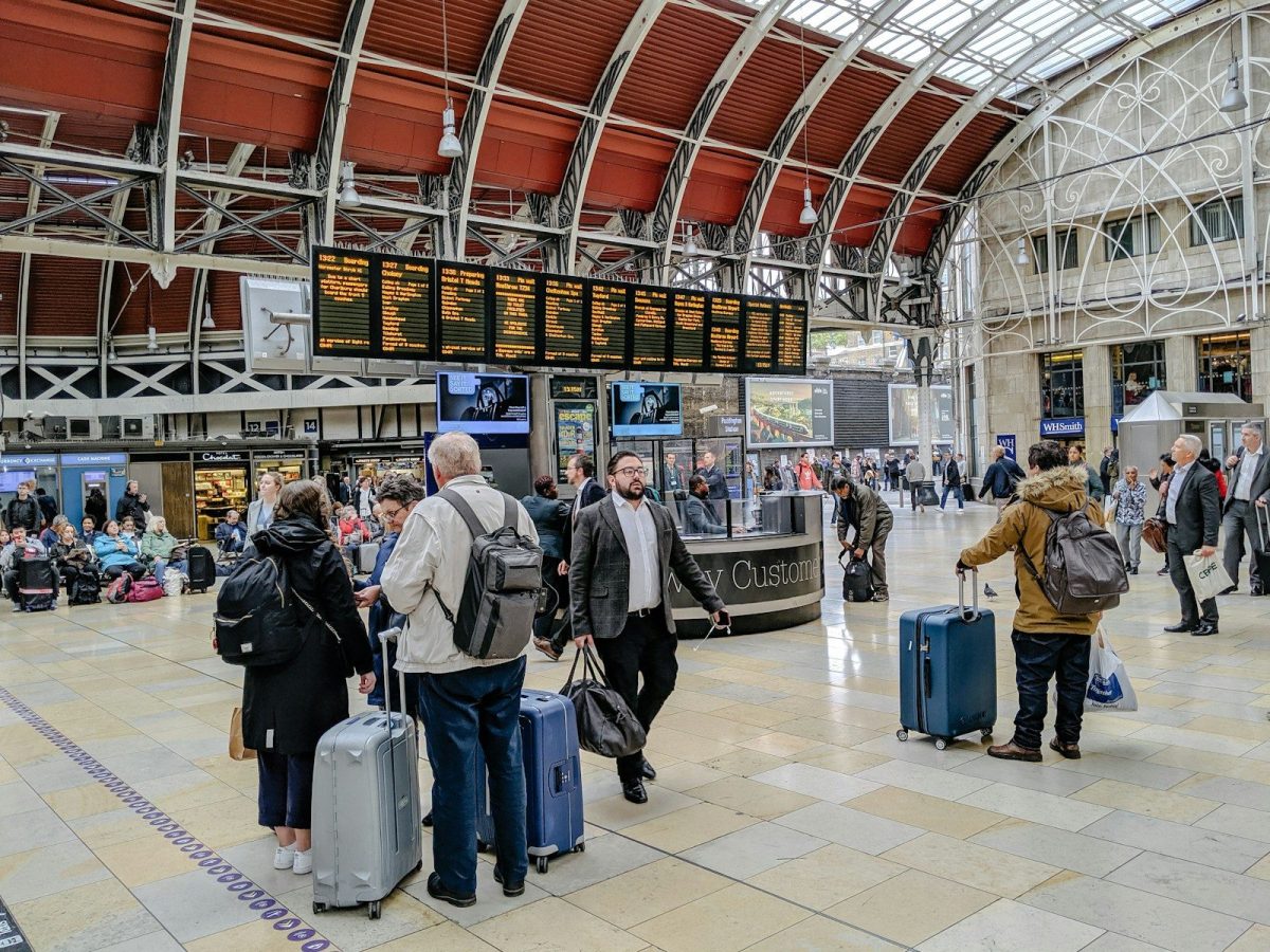 7 Tricks for Finding the Best Airfare Deals in 2026 3 people walking on train station