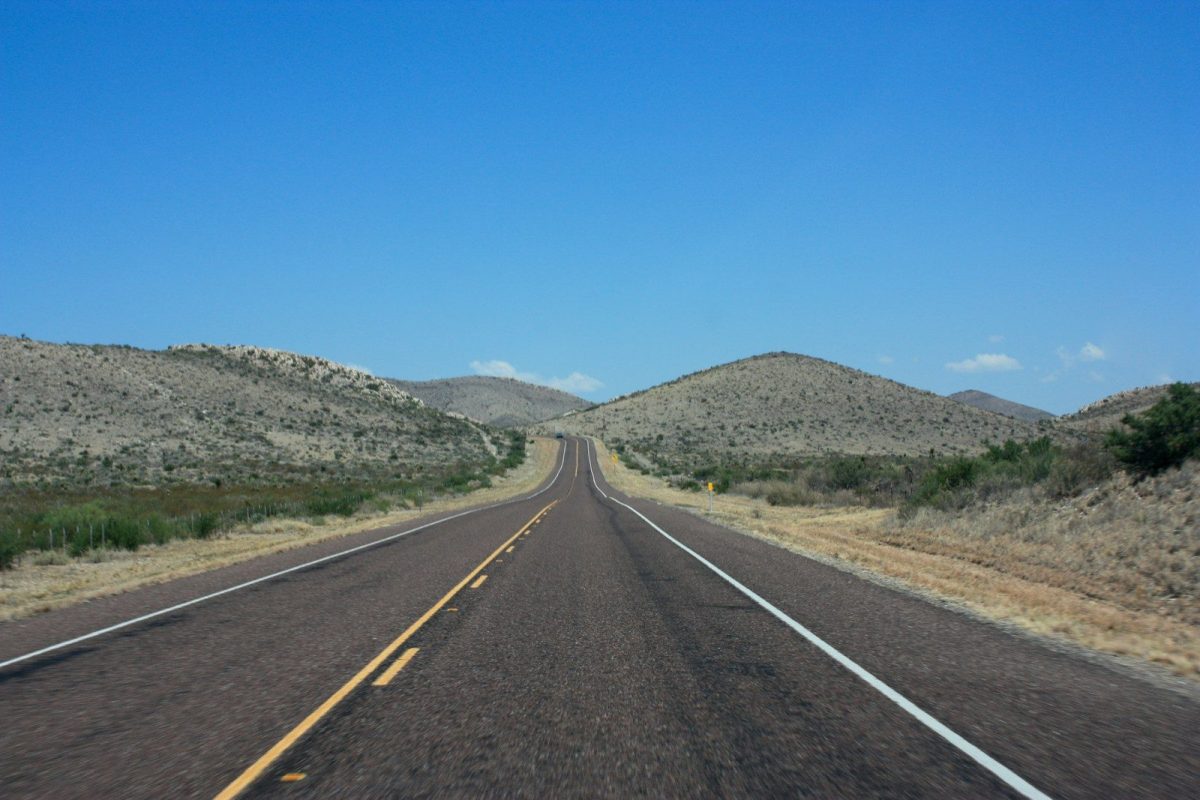 8 of America's Oldest Roadside Stops You Can Still See 7 an empty road in the middle of the desert