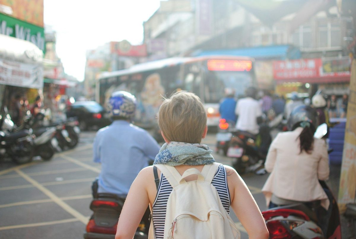 9 Behaviors Locals Hate About Tourists 6 woman wearing backpack walking on road