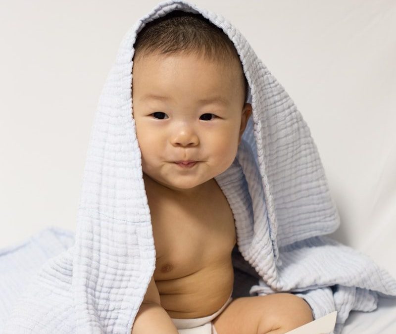 baby wearing blue blanket