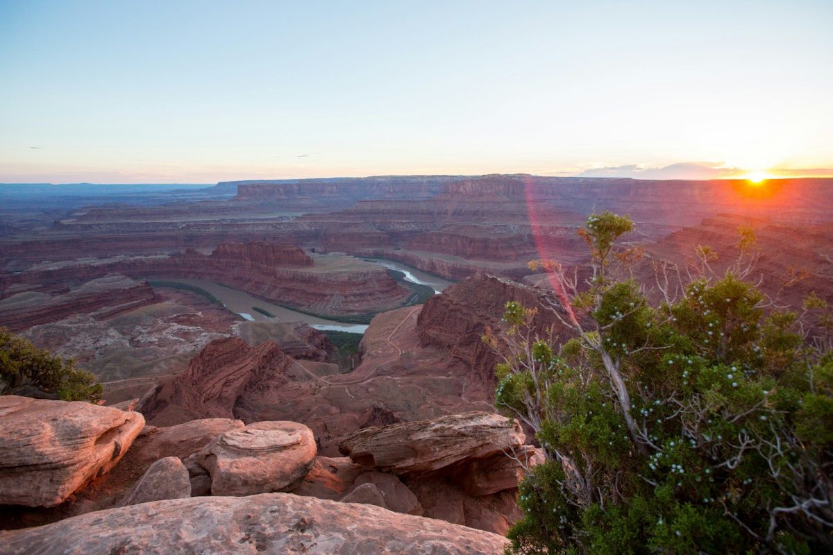 8 Reasons Some European Travelers Are Rethinking U.S. Trips 6 The sun is setting over a canyon with a river running through it