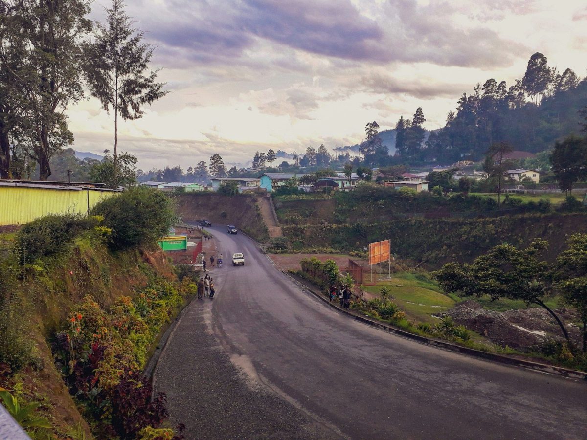 a long road with cars driving down it
