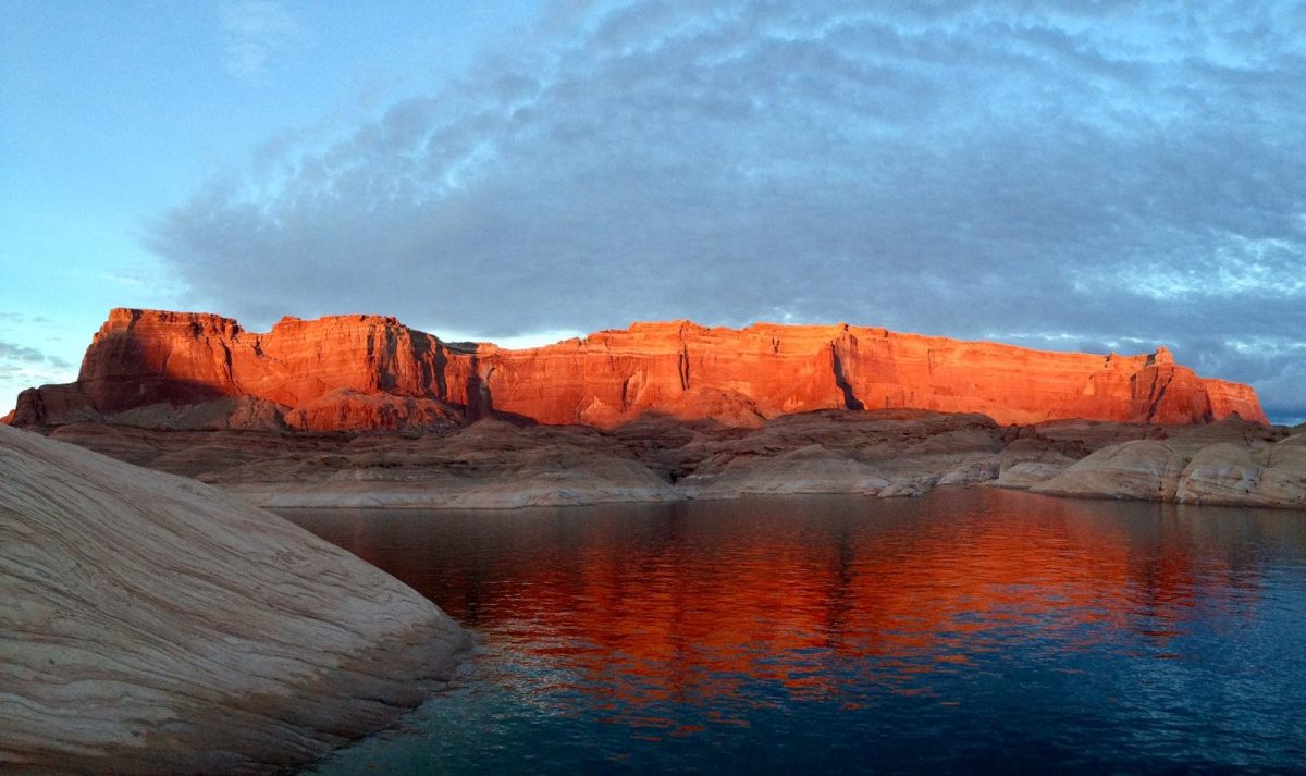 8 Must-Visit Lake Destinations in the U.S. for Summer Travelers 3 brown rocky mountain beside body of water under cloudy sky during daytime