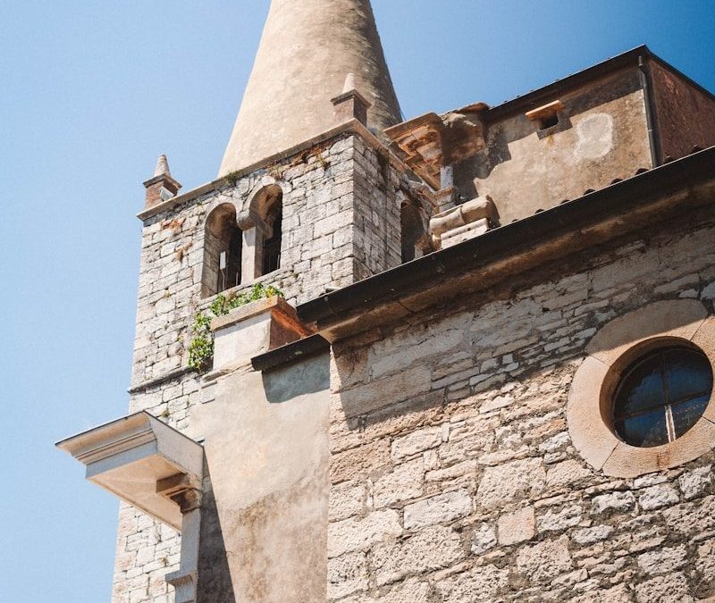 A tall tower with a clock on the top of it