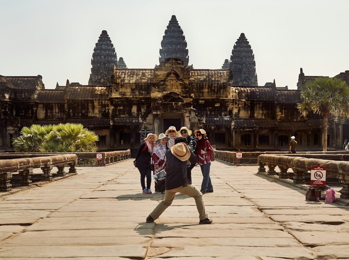 9 Behaviors Locals Hate About Tourists 8 a group of people walking across a stone bridge