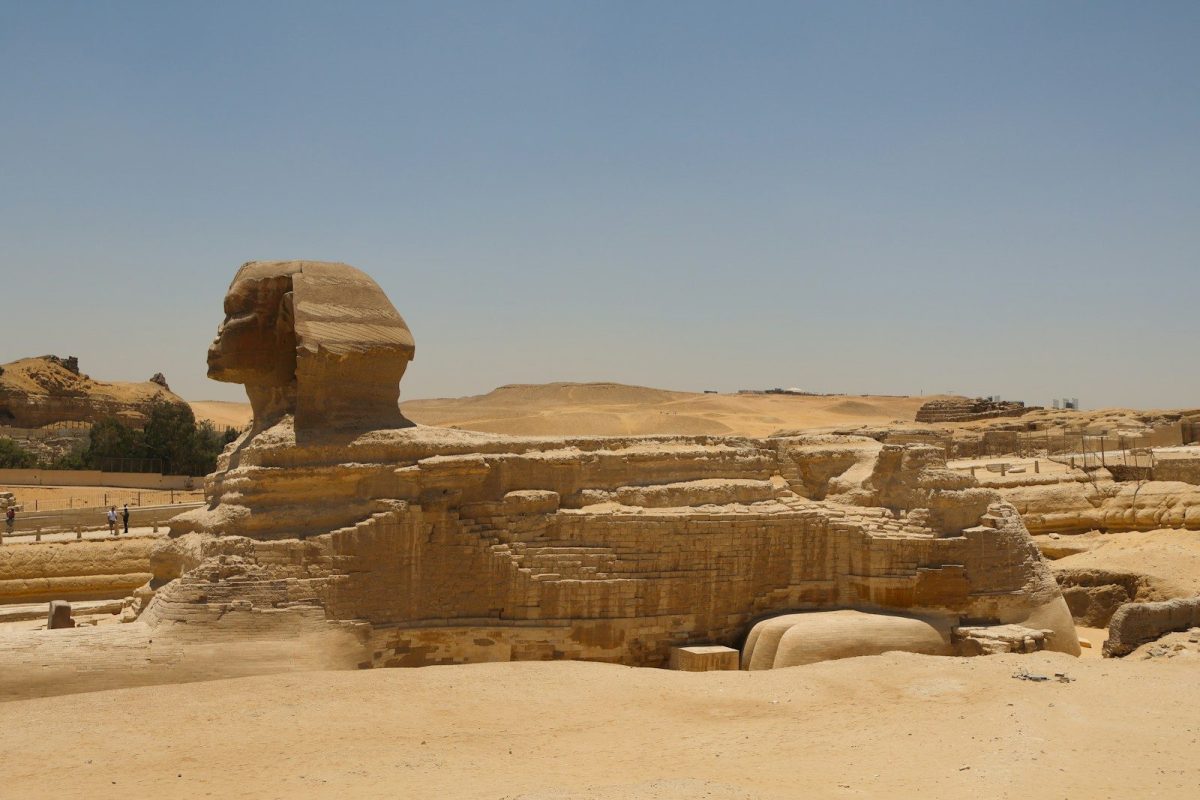 A large sphinx statue in the middle of a desert