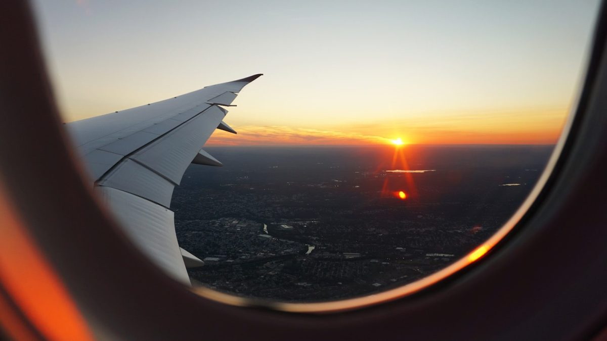7 Tricks for Finding the Best Airfare Deals in 2026 2 airplanes window view of sky during golden hour