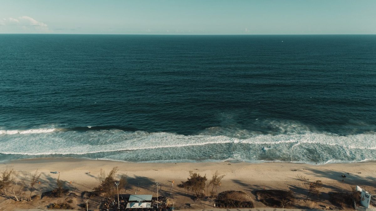 The ocean waves crash on a sandy beach.