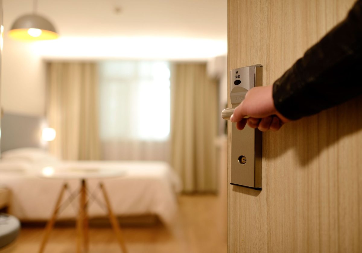5 Hotel Room Locations You May Regret More Than a Bad View 5 A soft lit hotel room entrance, welcoming guests with luxury appeal and comfort.