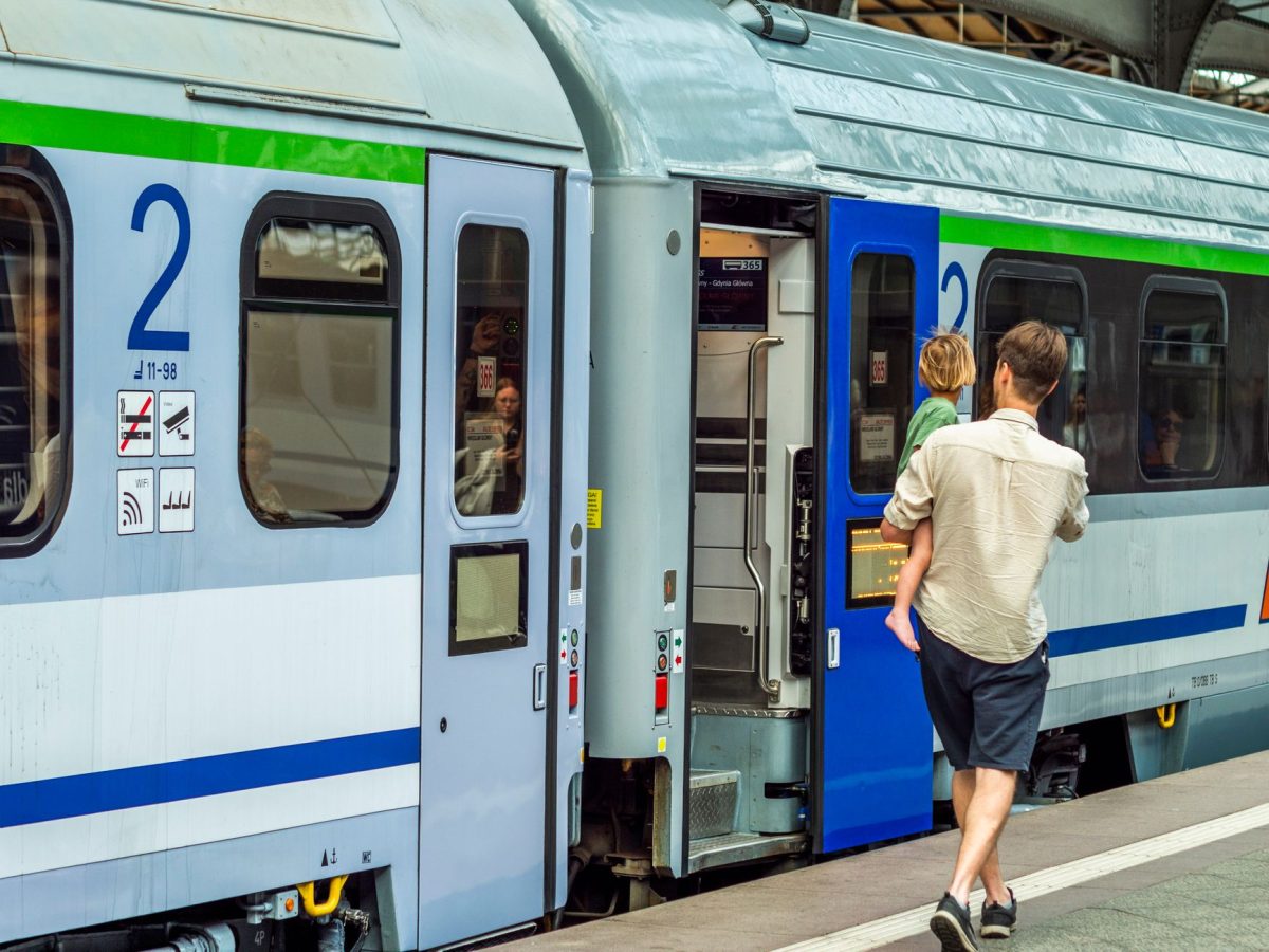 5 Transit Transfer Moves That Help City Visitors Skip the Worst Waits 4 Adult male with child boarding train at railway station. Urban travel scene.