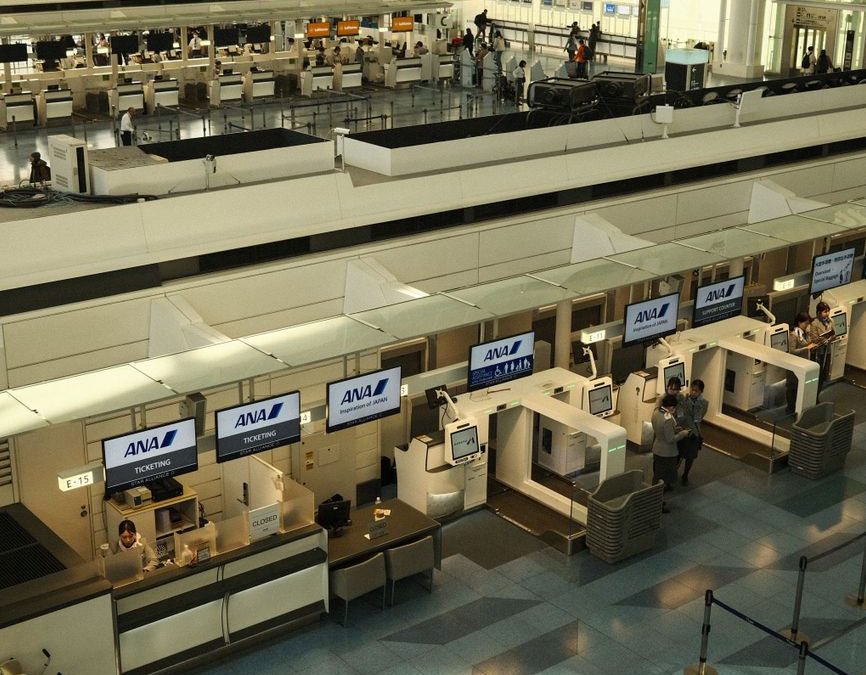 5 Luggage Storage Moves That Can Rescue the Awkward Last Day of a Trip 3 Aerial view of the check in counters at Haneda Airport, Tokyo, showcasing modern architecture.