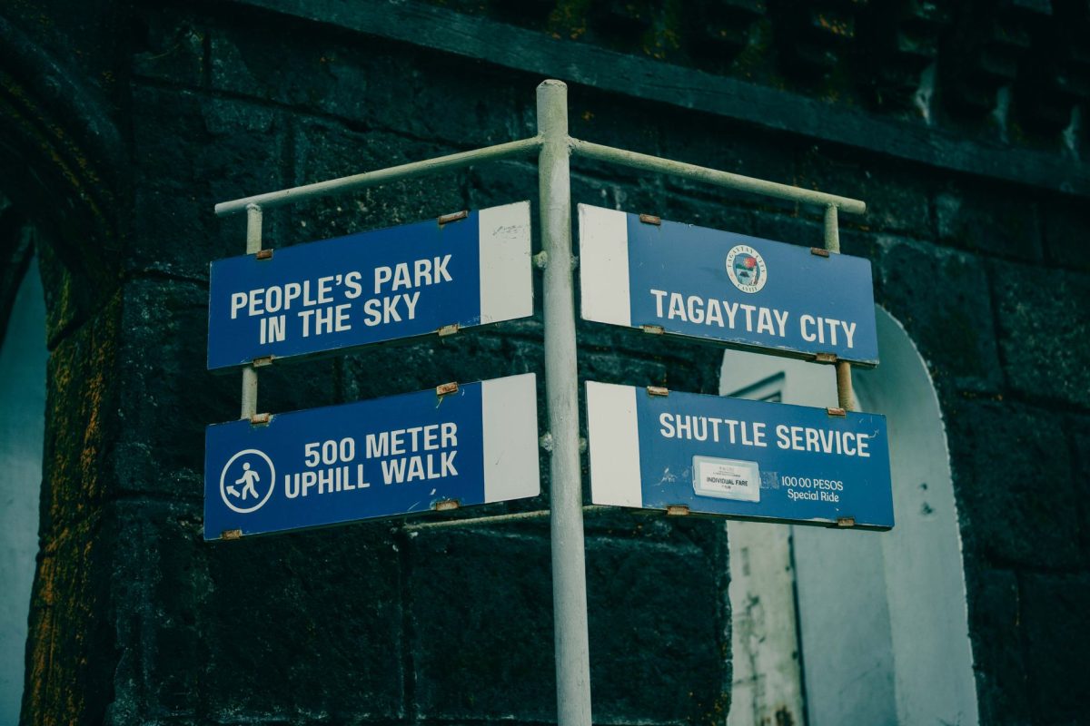 5 National Park Shuttle Snags That Can Burn Half Your Day Trip 4 Blue directional signs for People's Park in Tagaytay City, Philippines, with shuttle service details.