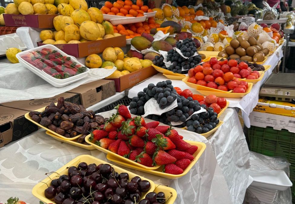 Colorful spread of fresh fruits at an urban market in São Paulo, Brazil.