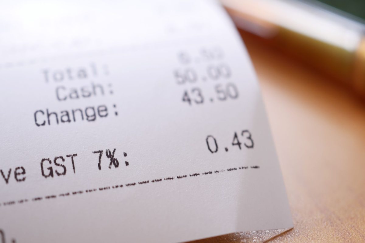 Detailed close up image of a shopping receipt showing GST and total changes.