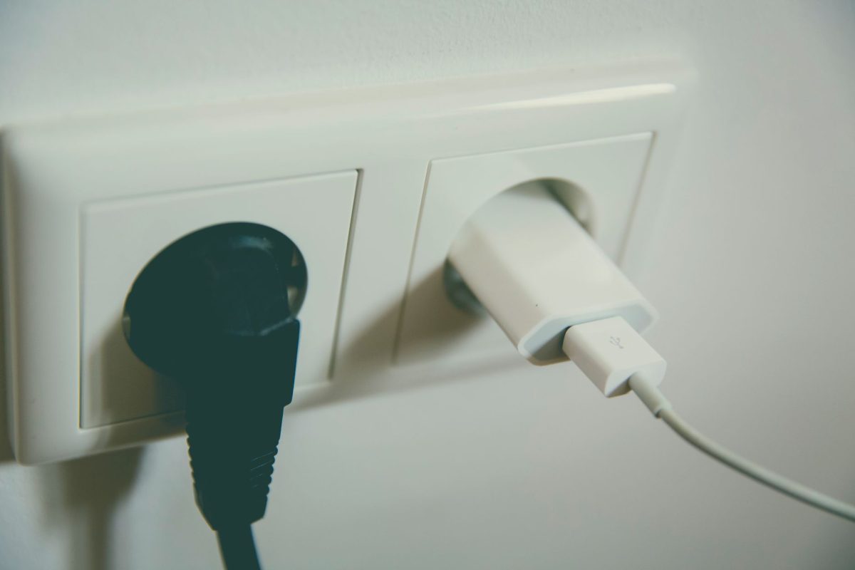 A close up view of a wall outlet with two plugs inserted, capturing the simplicity of electrical connectivity.