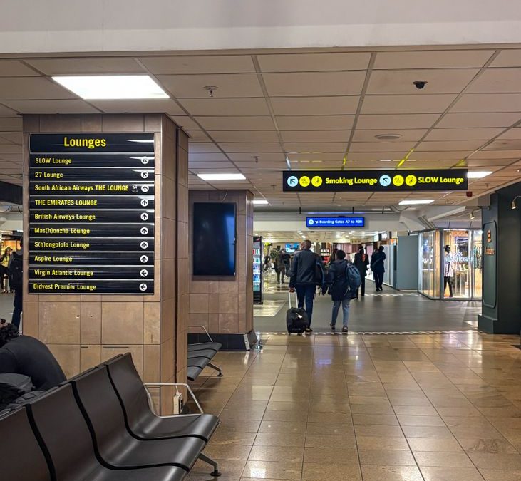 Modern airport interior showcasing seating and clear lounge signage for travelers.